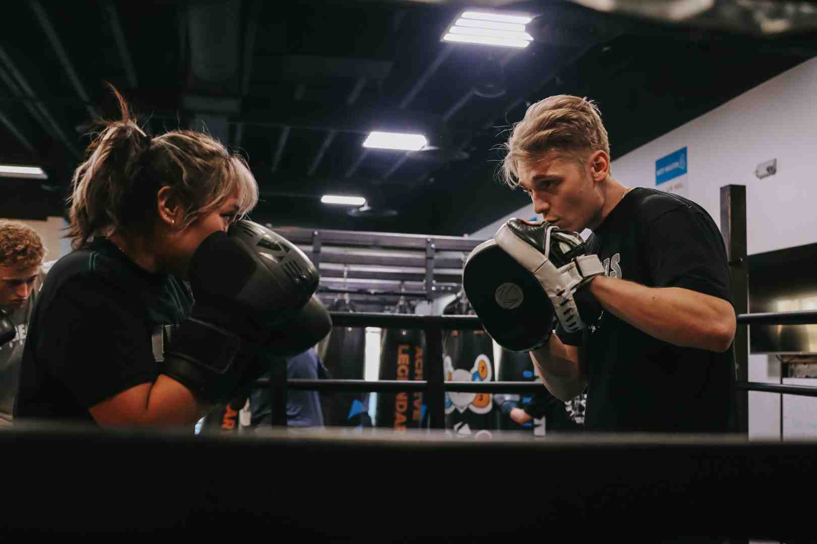 Two boxers sparring safely with large training gloves at Legends Boxing